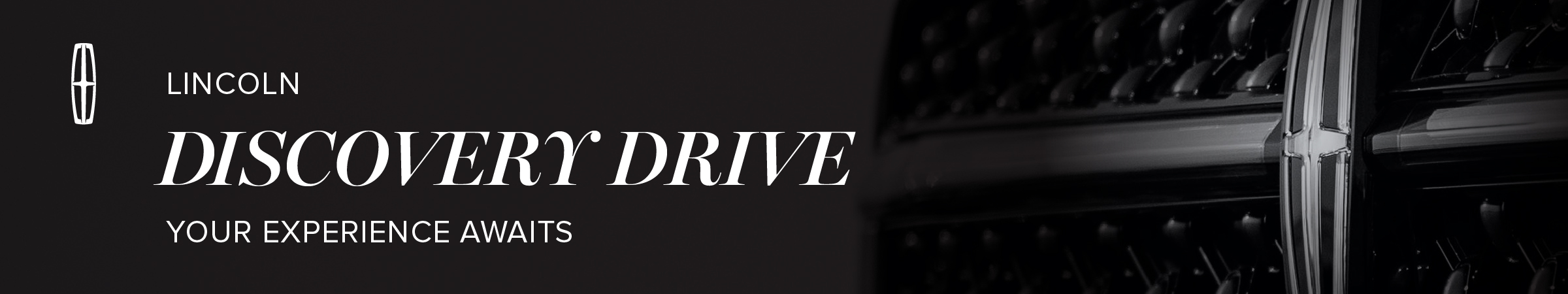 Lincoln Discovery Drive banner with logo and grille detail, inviting an exclusive experience.