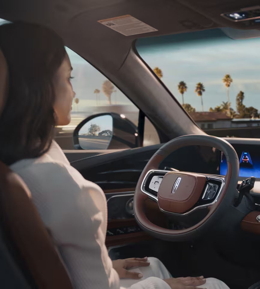 Person in a car using advanced driver-assistance technology, showcasing modern automotive innovation.